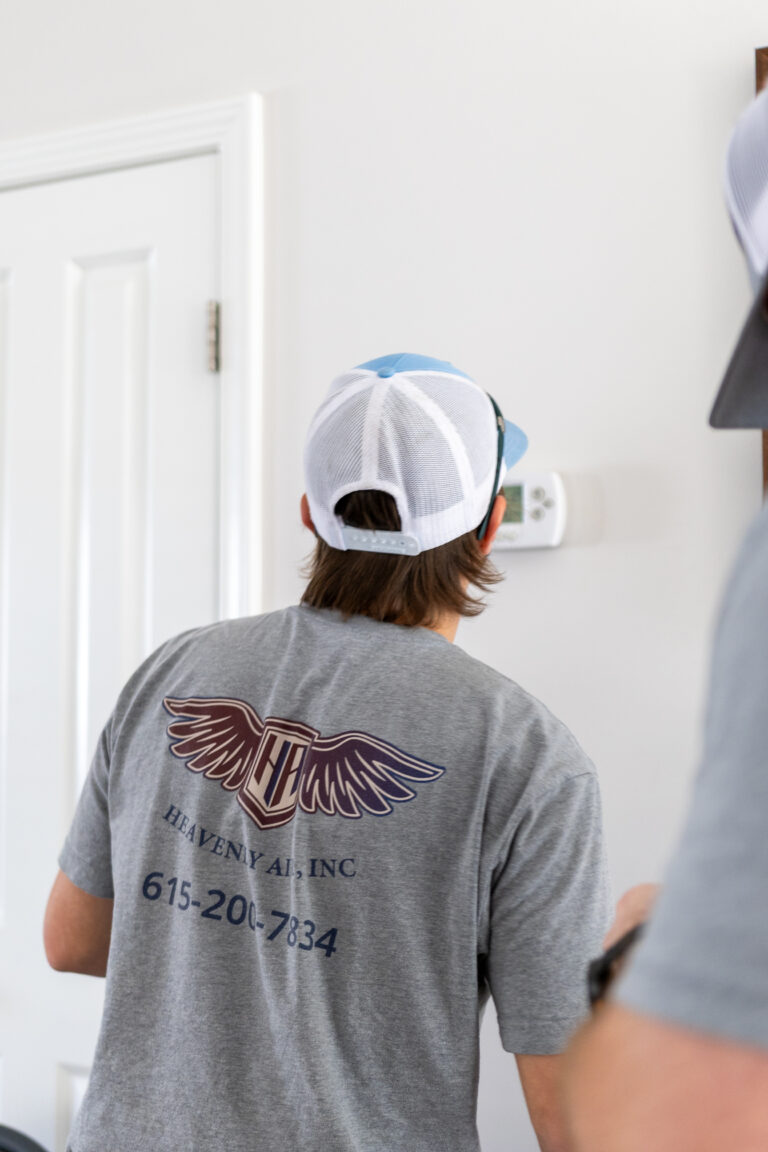Technician installing a thermostat
